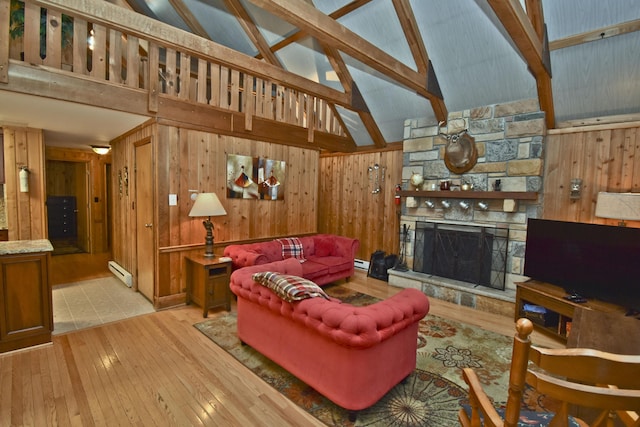 1046 Maple Dr, Pocono Lake, PA 18347 - living room with baseboard heating, wood walls, high vaulted ceiling, hardwood / wood-style flooring, and a stone fireplace