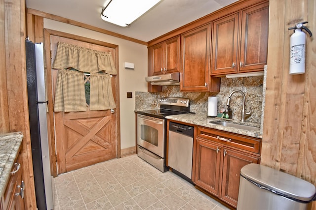 1046 Maple Dr, Pocono Lake, PA 18347 - kitchen with appliances with stainless steel finishes, under cabinet range hood, backsplash, and light stone countertops