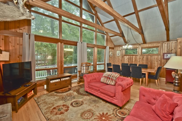 1046 Maple Dr, Pocono Lake, PA 18347 - living area featuring wood walls, high vaulted ceiling, beam ceiling, wood finished floors, and a chandelier