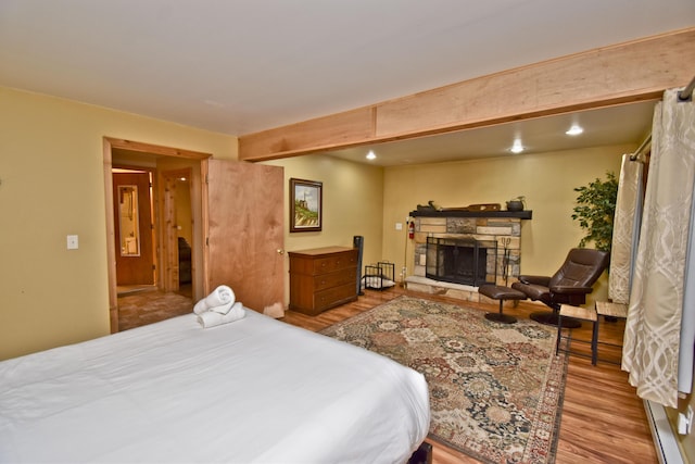 1046 Maple Dr, Pocono Lake, PA 18347 - bedroom featuring wood finished floors and a stone fireplace