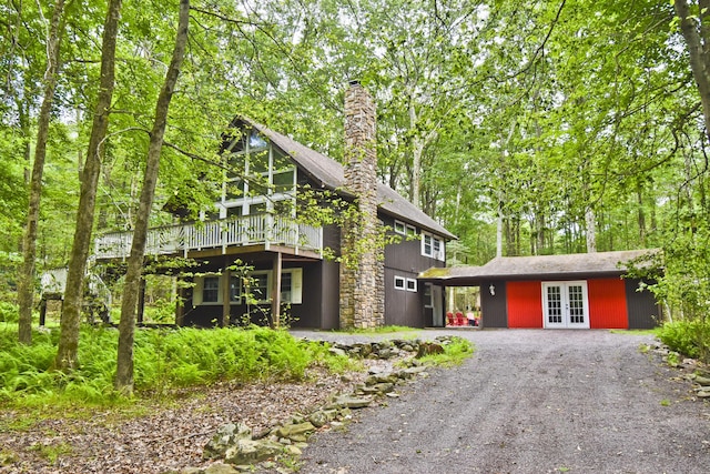 1046 Maple Dr, Pocono Lake, PA 18347 - chalet / cabin featuring french doors, gravel driveway, a deck, and a chimney