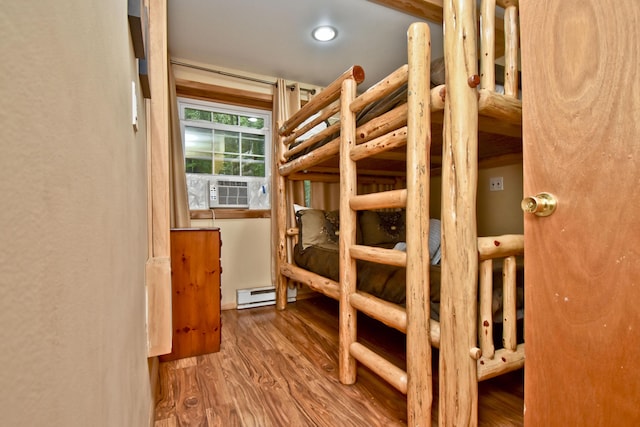 1046 Maple Dr, Pocono Lake, PA 18347 - unfurnished bedroom featuring cooling unit, a baseboard radiator, and wood finished floors