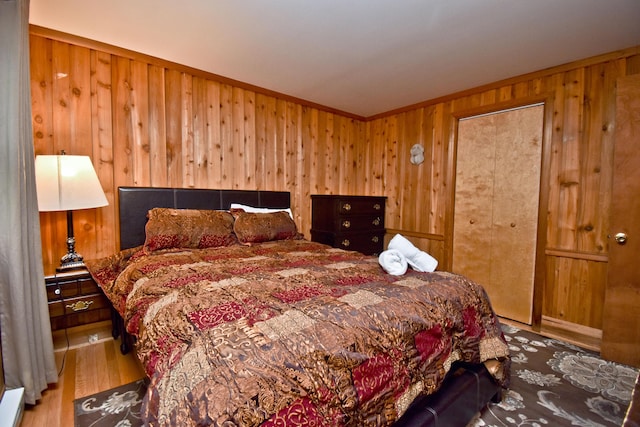 1046 Maple Dr, Pocono Lake, PA 18347 - bedroom with wood walls, wood finished floors, and ornamental molding