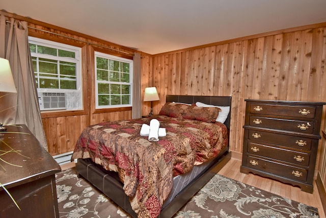 1046 Maple Dr, Pocono Lake, PA 18347 - bedroom with cooling unit, wood walls, wood finished floors, and a baseboard radiator