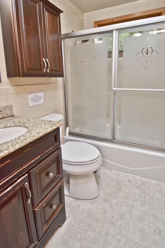 1046 Maple Dr, Pocono Lake, PA 18347 - bathroom featuring vanity, combined bath / shower with glass door, tile patterned floors, and backsplash