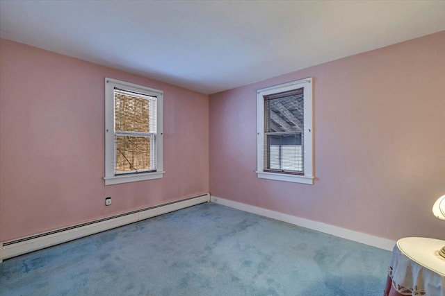 carpeted spare room featuring baseboards and a baseboard radiator