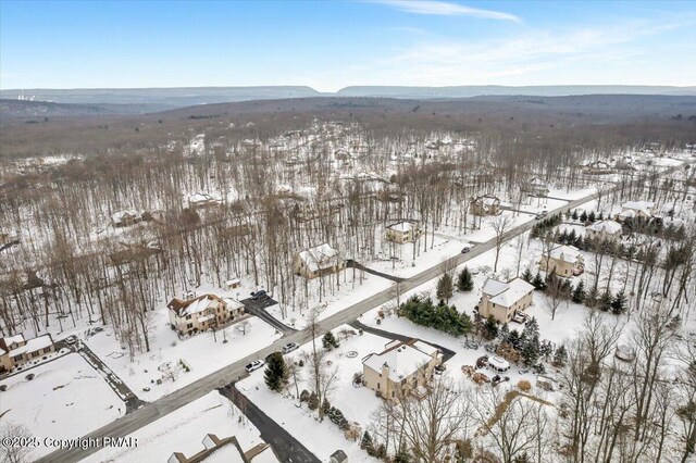 snowy aerial view with a mountain view