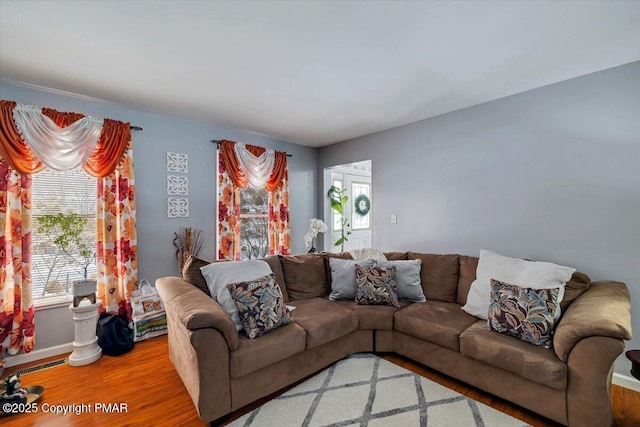 living room with light wood-style floors and visible vents