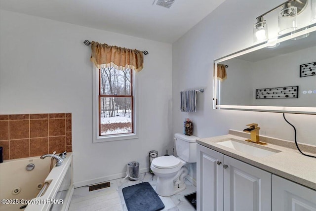 full bath with visible vents, baseboards, toilet, a whirlpool tub, and vanity