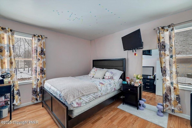 bedroom featuring light wood-type flooring and baseboards