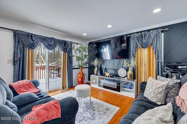 living room featuring wood-type flooring and ornamental molding