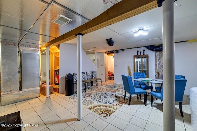 finished basement with visible vents and tile patterned floors