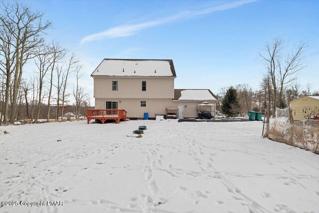 snow covered property featuring a deck