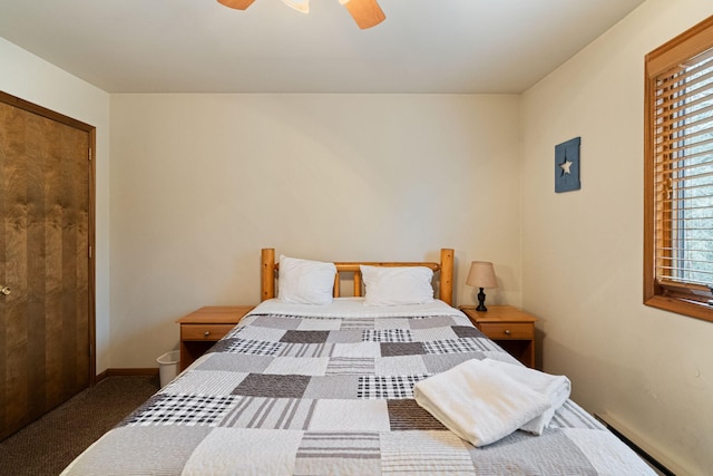 bedroom with a baseboard radiator, carpet flooring, ceiling fan, and baseboards