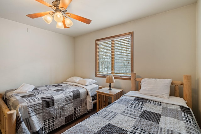 bedroom with ceiling fan and dark wood finished floors