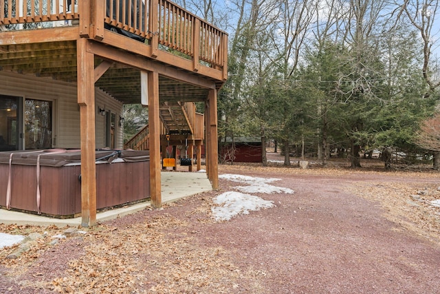 view of yard with a patio, stairway, a wooden deck, and a hot tub