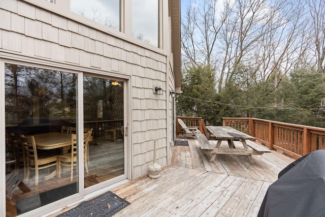 wooden deck featuring outdoor dining space