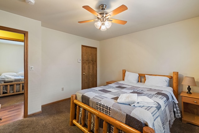 bedroom with ceiling fan, carpet flooring, and baseboards