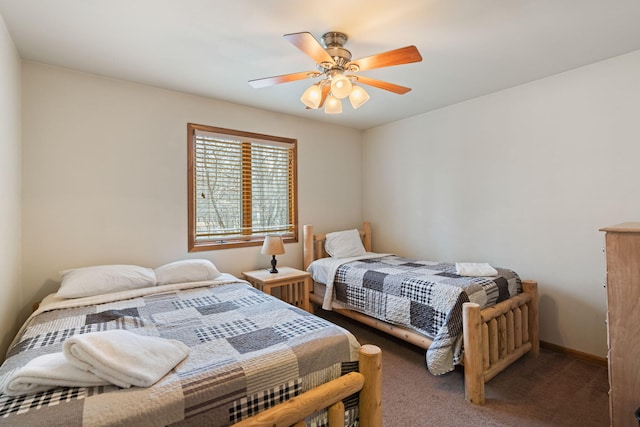 carpeted bedroom with a ceiling fan and baseboards