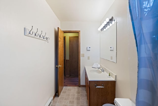 bathroom featuring toilet, baseboards, and vanity