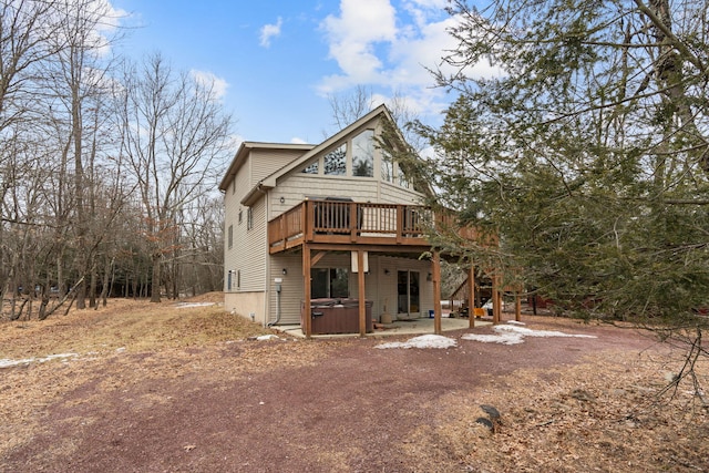 view of front facade featuring a hot tub and a wooden deck