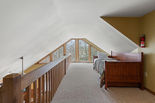 bedroom featuring lofted ceiling and carpet flooring