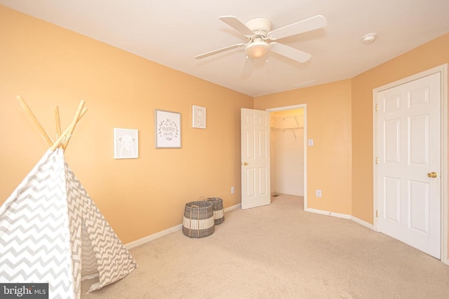 playroom featuring ceiling fan, baseboards, and carpet flooring