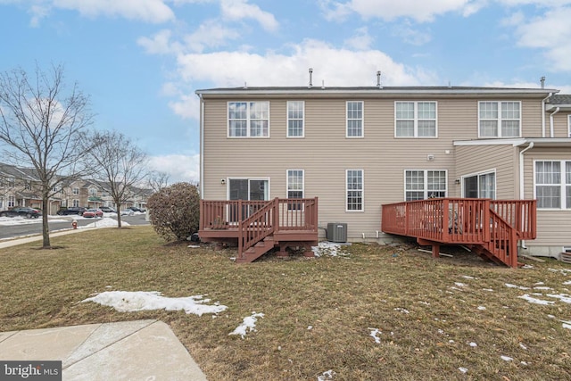 rear view of house featuring central air condition unit, a lawn, and a wooden deck