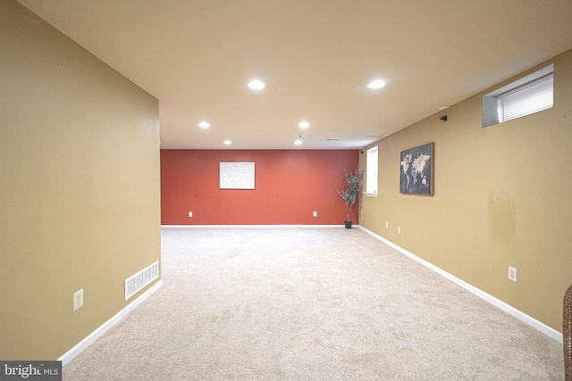 basement with carpet floors, baseboards, visible vents, and recessed lighting