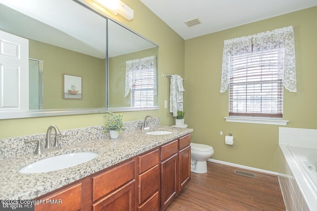 bathroom with a sink, visible vents, and a healthy amount of sunlight