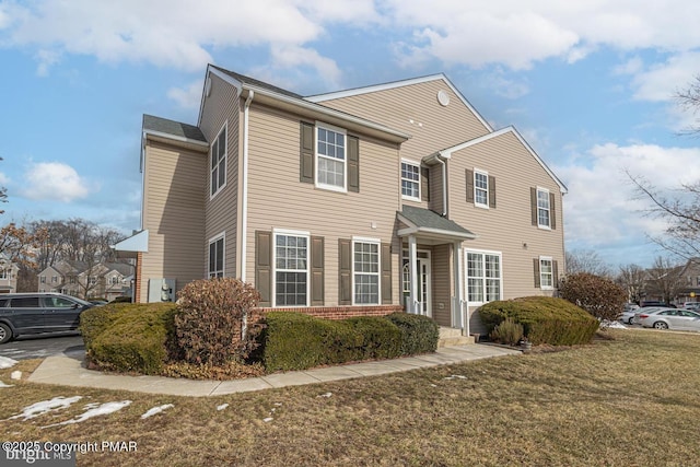 view of front of house with a front lawn and brick siding