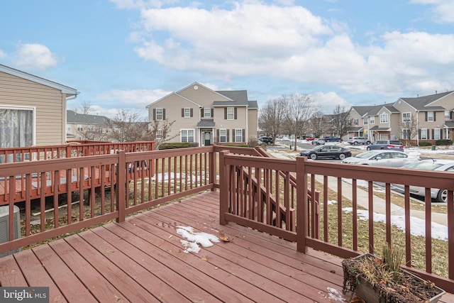 wooden deck featuring cooling unit and a residential view