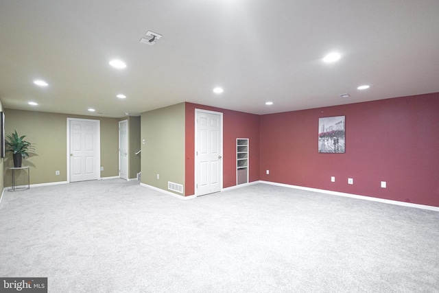 below grade area with carpet, visible vents, and recessed lighting