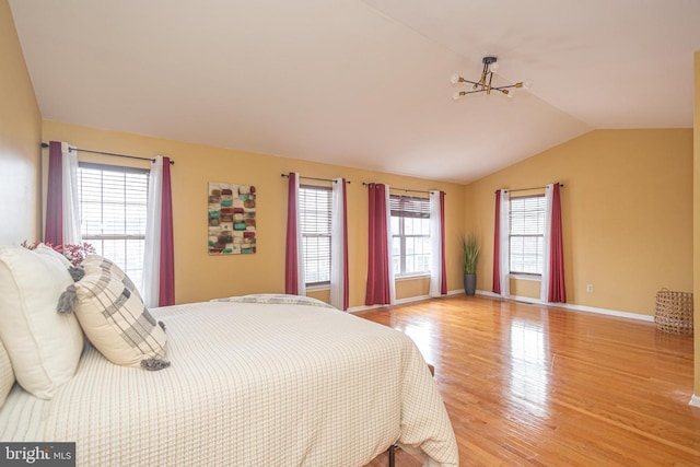 bedroom featuring vaulted ceiling, wood finished floors, and baseboards