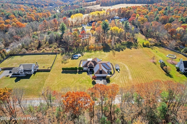 birds eye view of property featuring a rural view and a forest view