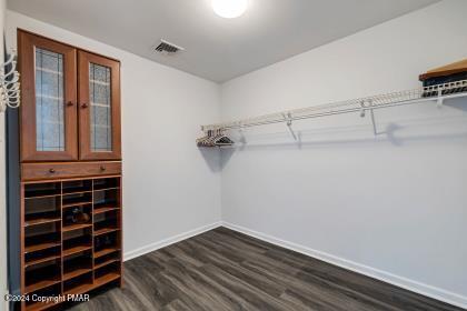 walk in closet featuring visible vents and dark wood-style flooring