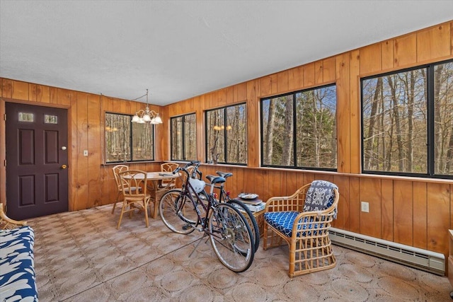 1232 Redwood Ter, Pocono Pines, PA 18350 - dining space featuring wood walls, an inviting chandelier, and baseboard heating