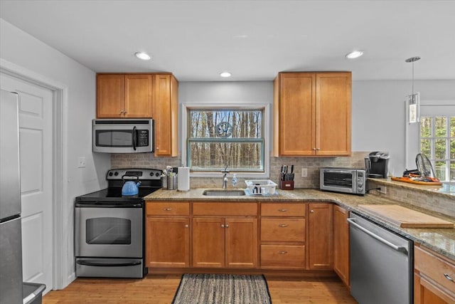 1232 Redwood Ter, Pocono Pines, PA 18350 - kitchen with decorative backsplash, a sink, light stone counters, a toaster, and stainless steel appliances