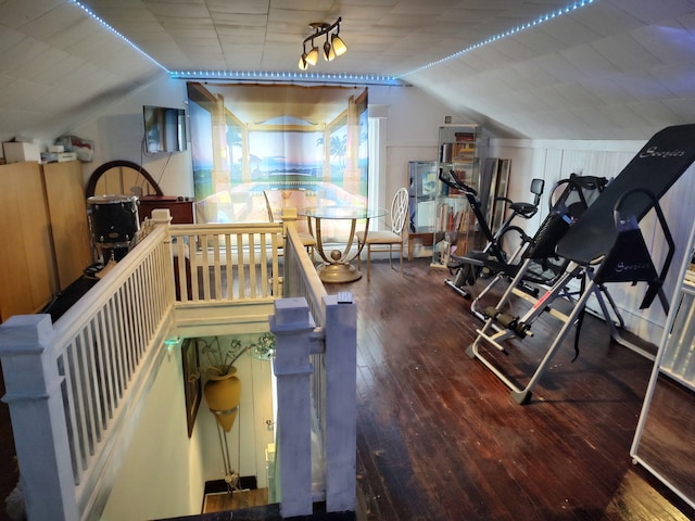 exercise room featuring vaulted ceiling and hardwood / wood-style flooring