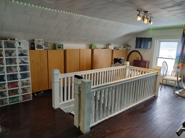 interior space featuring hardwood / wood-style floors and vaulted ceiling