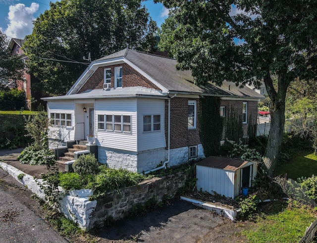 view of front of home featuring an outbuilding and a shed