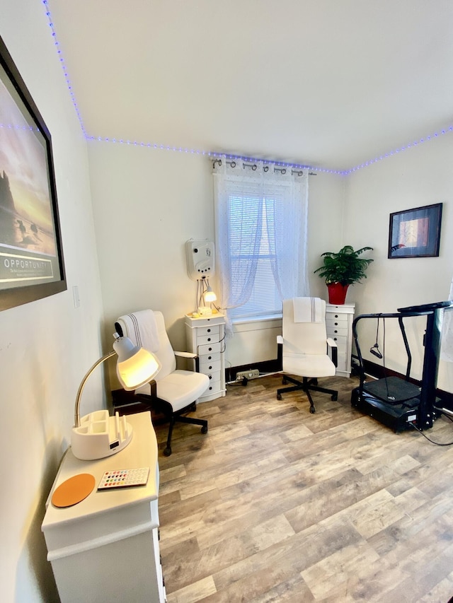 living area with wood finished floors and baseboards