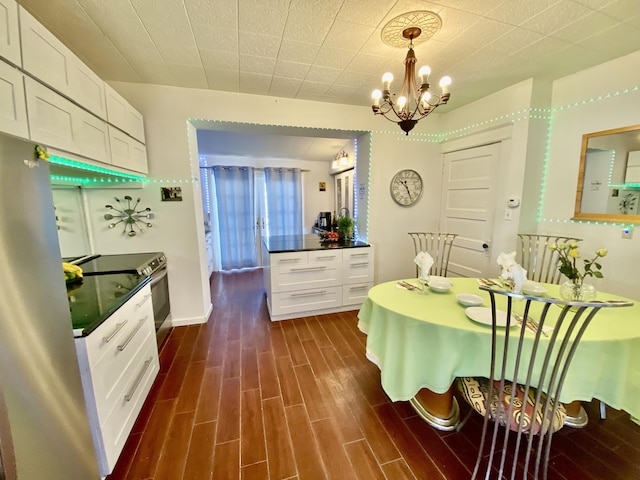 dining room with dark wood-style floors, baseboards, and a chandelier