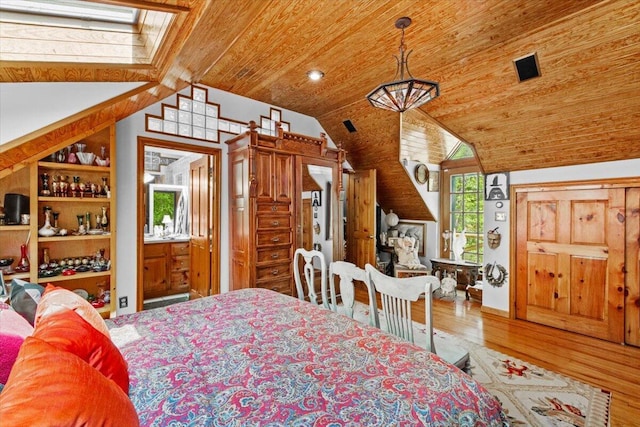 bedroom featuring lofted ceiling, wood ceiling, and wood finished floors