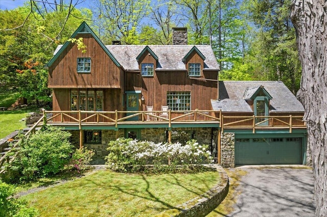 1341 Beaver Valley Rd, Stroudsburg, PA 18360 - view of front facade with a chimney, asphalt driveway, a garage, and a front yard