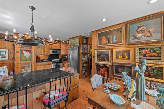 kitchen featuring stainless steel appliances, light wood-style floors, recessed lighting, and brown cabinetry