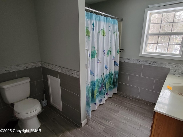 bathroom with hardwood / wood-style flooring, vanity, tile walls, and a shower with shower curtain