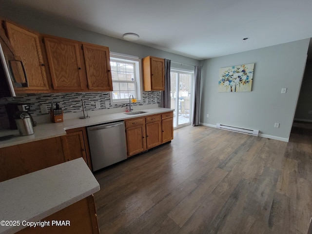 kitchen with sink, hardwood / wood-style flooring, dishwasher, backsplash, and a baseboard heating unit