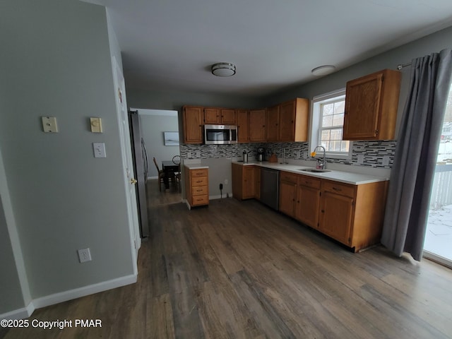 kitchen featuring appliances with stainless steel finishes, dark hardwood / wood-style floors, sink, and decorative backsplash