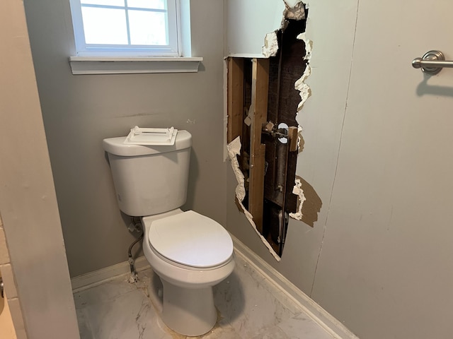 1209 Fern Dr, Pocono Summit, PA 18346 - half bathroom with toilet and marble look tiles